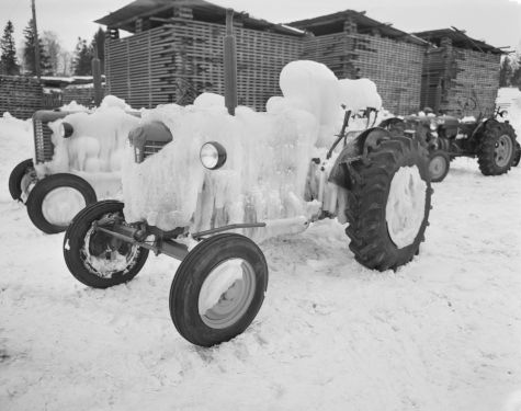 Ice-covered tractors at a lumber yard.