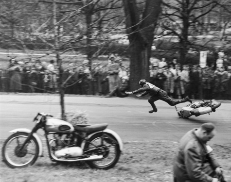 A man falls on a motorcycle