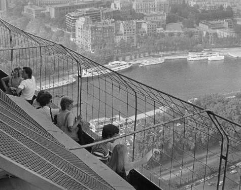 People looking down from an observation tower.